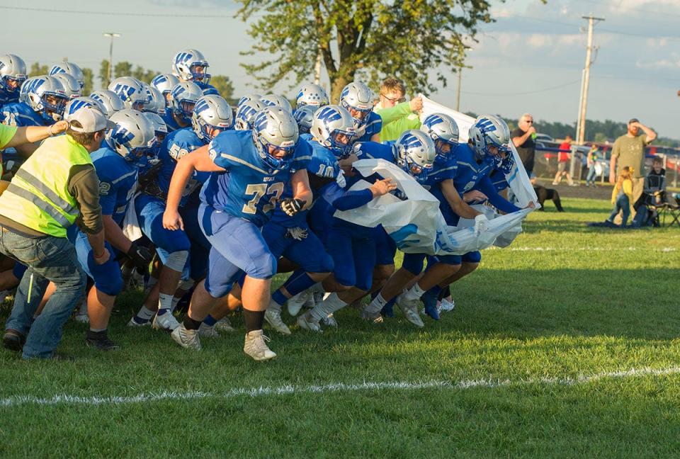 Wynford bursts through the banner ahead of its game against Buckeye Central.