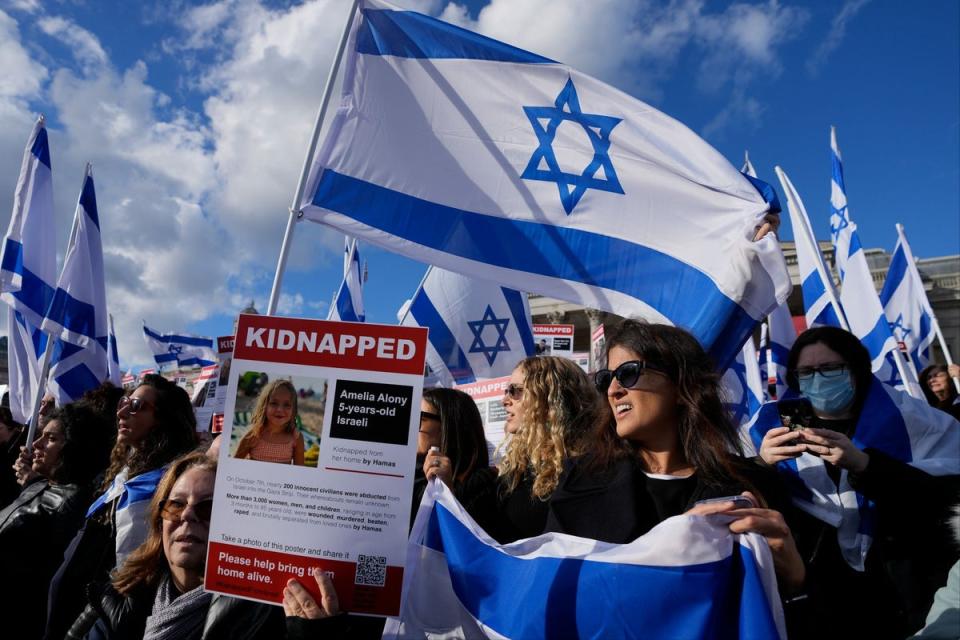 Israeli supporters show placards with the faces and names of people believed to be taken hostage and held in Gaza, during a protest in Trafalgar Square on Sunday, October 22 (AP)