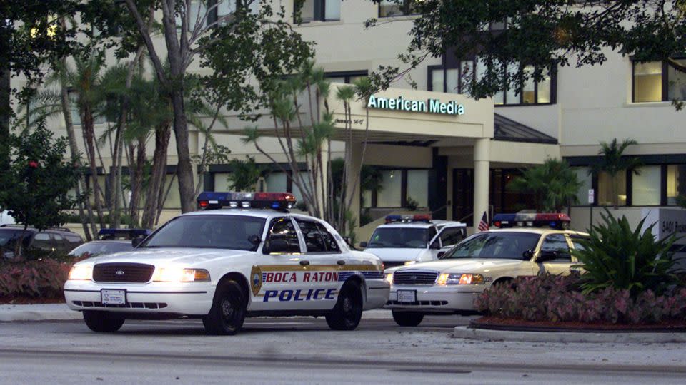 Police cars are parked outside the American Media building in Boca Raton on  Oct. 8, 2001 where environmental tests detected anthrax bacteria. - Luis M. Alvarez/AP