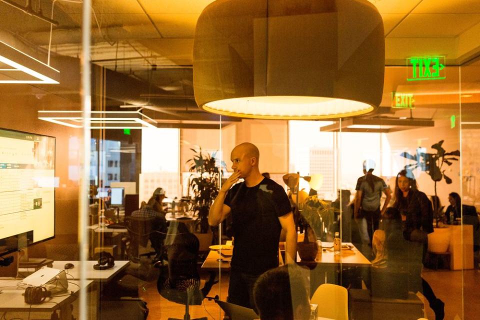 PART OF YOUR WORLD: Armstrong with staffers at Coinbase’s San Francisco headquarters. The CEO wants the company to eventually become the crypto equivalent of a global bank.