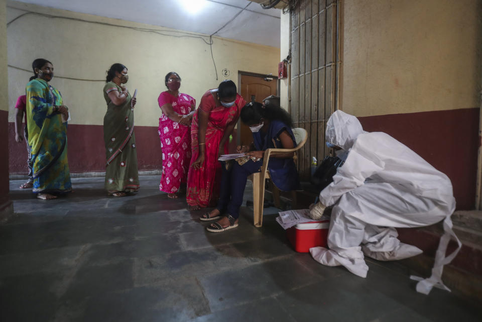 People register themselves to get tested during a door-to-door screening for COVID-19 people at Dharavi, one of Asia's largest slums, in Mumbai, India, Wednesday, March 17, 2021. (AP Photo/Rafiq Maqbool)