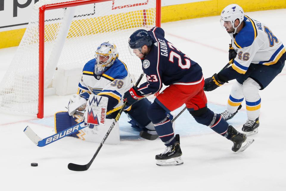 Columbus Blue Jackets center Brendan Gaunce (23) tries to hit a rebound off St. Louis Blues goaltender Charlie Lindgren (39) during the second period of the NHL preseason hockey game at Nationwide Arena in Columbus on Wednesday, Sept. 29, 2021.