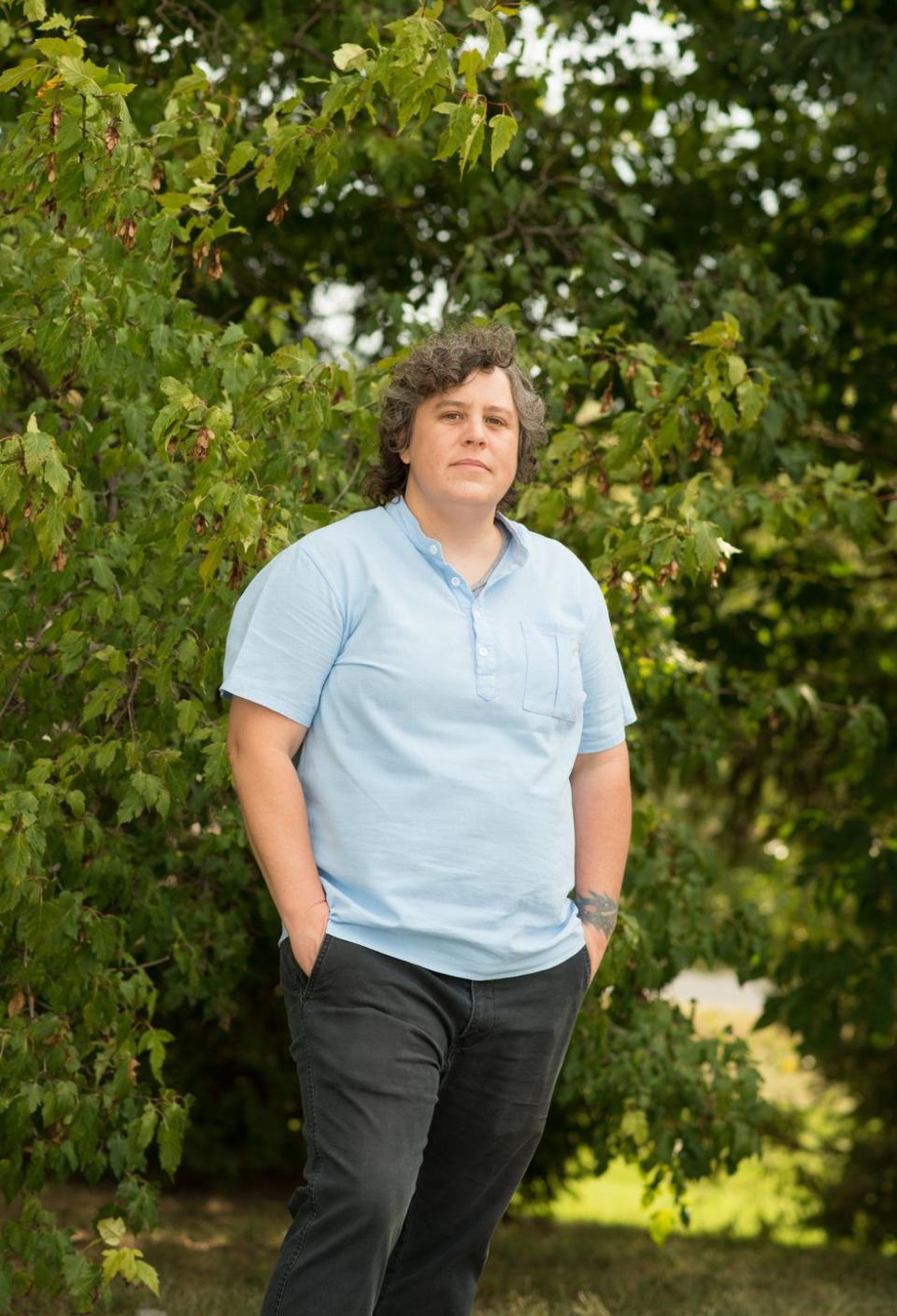 woman standing in front of a bush