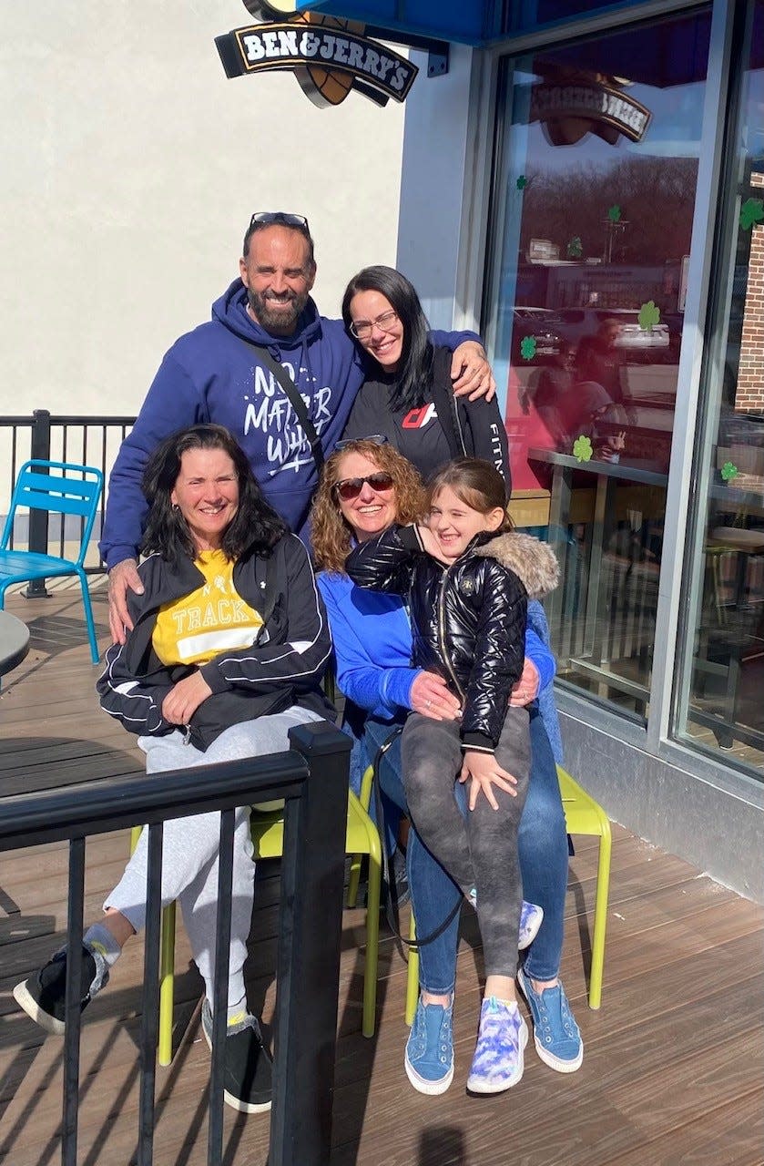Dr. Stephanie Krusz (seated, right) got together Sunday with Glen Rodrigues (standing); his fiancée, Krystal Patch; sister Brenda and Rodrigues' daughter, Eva, to celebrate the six-month anniversary of Rodrigues' kidney transplant.