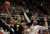 Oregon forward Satou Sabally, left, lays up a shot past Stanford's Francesca Belibi (5) during the first half of an NCAA college basketball game Monday, Feb. 24, 2020, in Stanford, Calif. (AP Photo/Ben Margot)