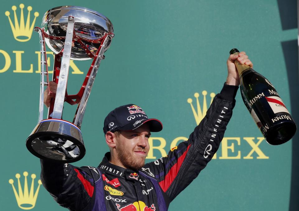 Red Bull Formula One driver Sebastian Vettel of Germany celebrates with his trophy on the podium after winning the Austin F1 Grand Prix at the Circuit of the Americas in Austin November 17, 2013.