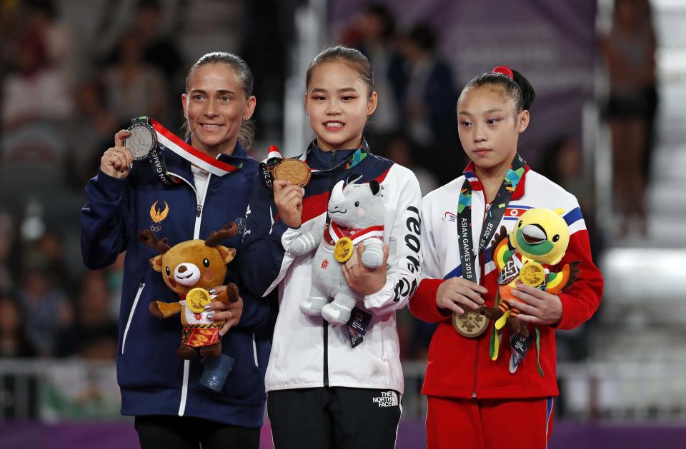 Oksana Chusovitina of Uzbekistan won a silver medal on vault at the Asian Games. At 43, Chusovitina is more than twice the age of gold medalist Yeo Seojeong of South Korea and bronze medalist Pyon Rye Yong of North Korea. (Reuters)