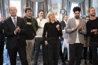 Laura Zimmermann, Co-President of Operation Libero, centre, together with Valentin Vogt, President of the Swiss Employers' Federation, Renato Perlini, campaign manager of Operation Libero, and Stefan Manser-Egli, Co-President of Operation Libero, from left, are pleased with the result of the vote at the meeting of opponents of the popular initiative "For moderate immigration" (restrictive initiative), on Sunday 27 September 2020 at the Hotel Schweizerhof in Bern, Switzerland. (Peter Klaunzer/Keystone via AP)