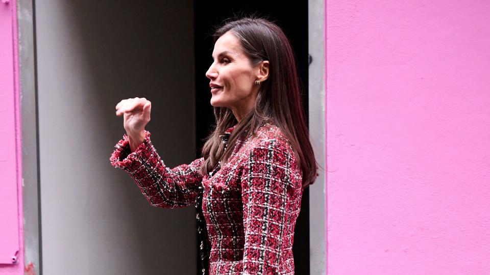 Queen Letizia walking in black flats and red tweed jacket