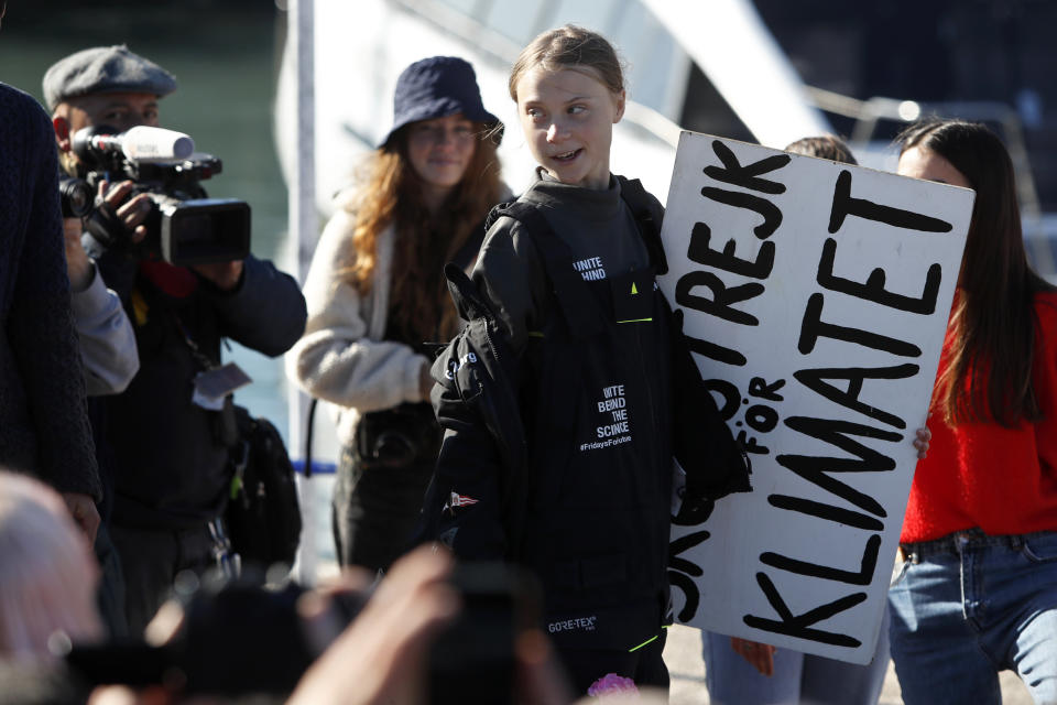 Climate activist Greta Thunberg holds a sign reading 'School strike for the climate' after arriving in Lisbon aboard the sailboat La Vagabonde Tuesday, Dec 3, 2019. Thunberg has arrived by catamaran in the port of Lisbon after a three-week voyage across the Atlantic Ocean from the United States. The Swedish teen sailed to the Portuguese capital before heading to neighboring Spain to attend the U.N. Climate Change Conference taking place in Madrid. (AP Photo/Armando Franca)