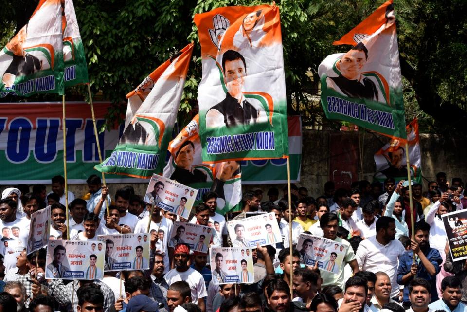 Supporters of the opposition Congress Party shout slogans as they protest against their leader Rahul Gandhi’s expulsion from parliament (AP)