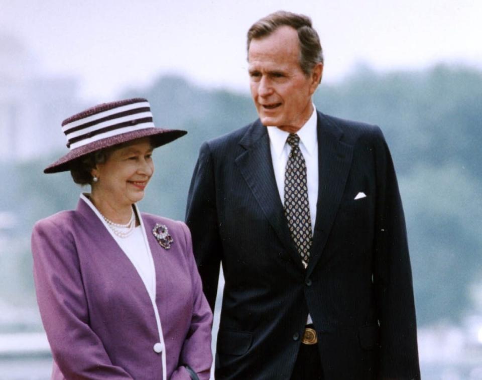 President George Bush talks to Queen Elizabeth II during a 14 May 1991 welcoming ceremony at the White House (AFP via Getty Images)