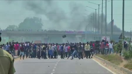 People pelt stones during a protest against the construction of a copper smelter by Vedanta Resources from the road, in Thoothukudi, Tamil Nadu, India in this still image from May 22, 2018 video footage. Video taken May 22, 2018. ANI via REUTERS TV