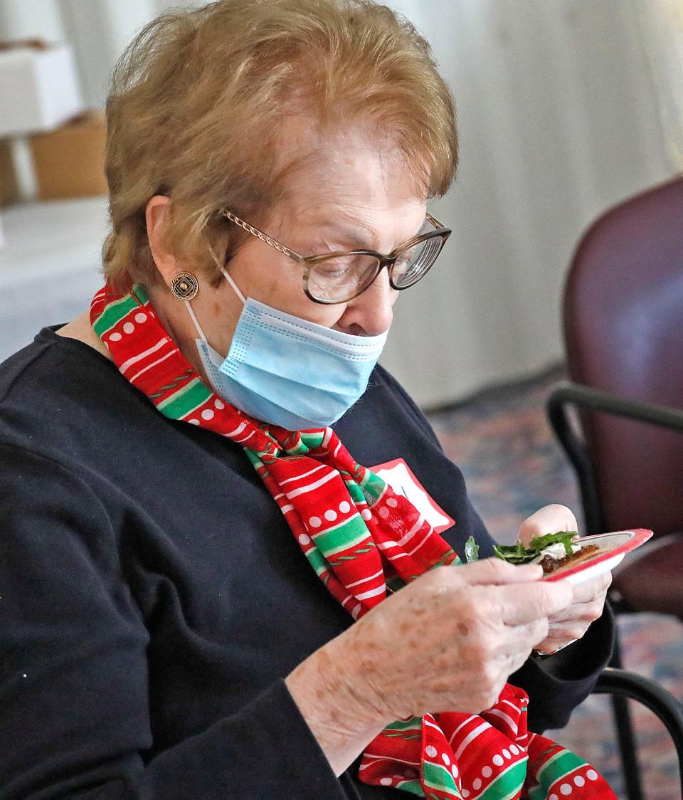 Ellen Bradford gets a sniff of fresh arugula on her appetizer.