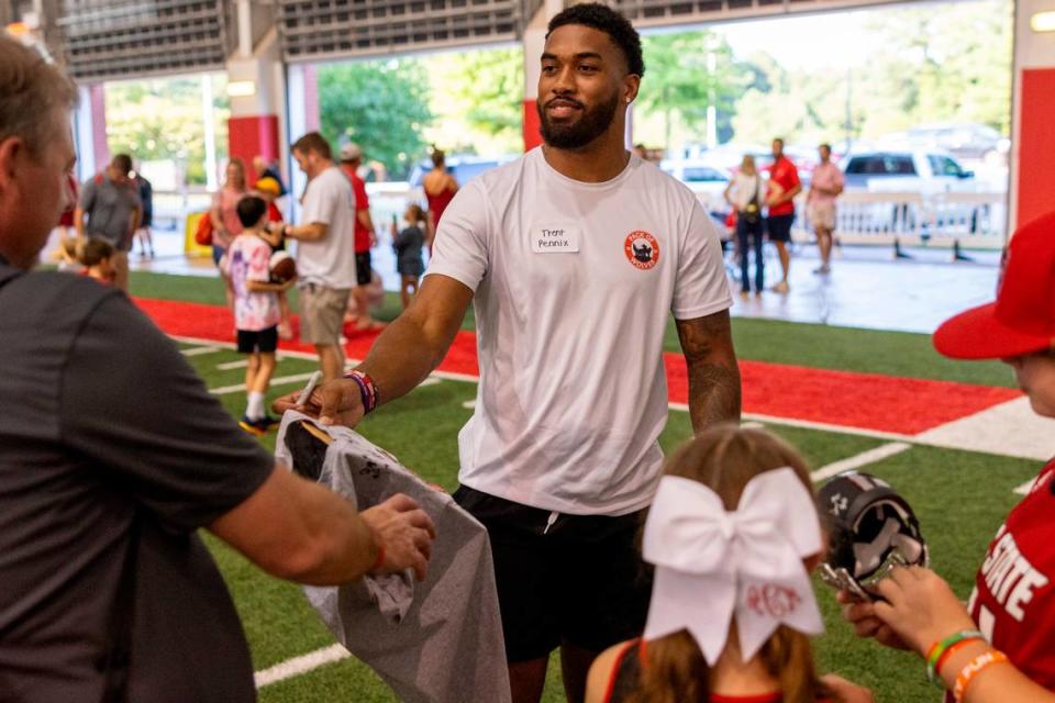 N.C. State’s Trent Pennix signs autographs during a ‘Meet the Pack’ event with football players and fans at the Close-King Indoor Practice Facility Saturday, Aug. 16, 2023.