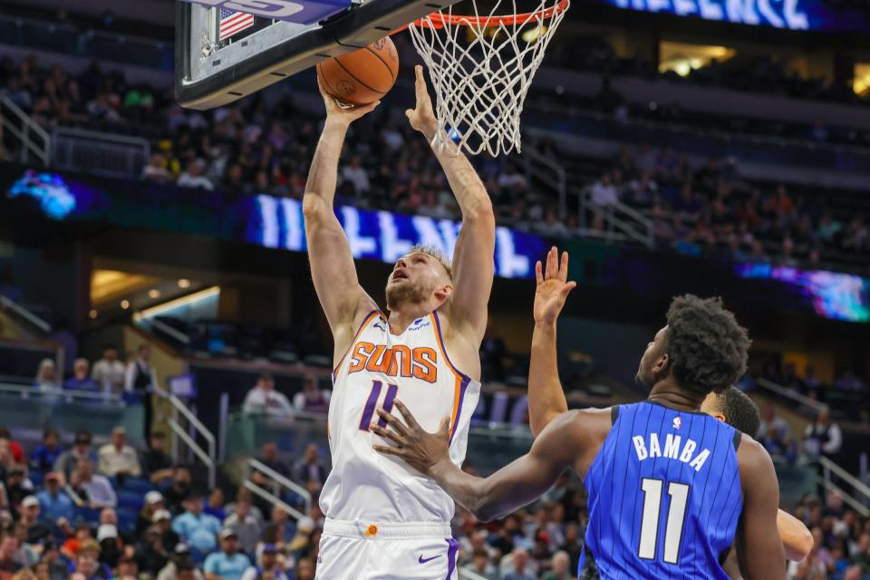 Nov 11, 2022; Orlando, Florida, USA; Phoenix Suns center Jock Landale (11) goes to the basket in front of Orlando Magic center Mo Bamba (11) during the second half at Amway Center. Mandatory Credit: Mike Watters-USA TODAY Sports