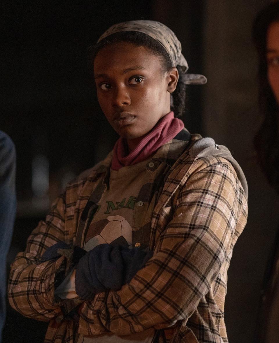 closeup of her in character wearing a flannel and bandana