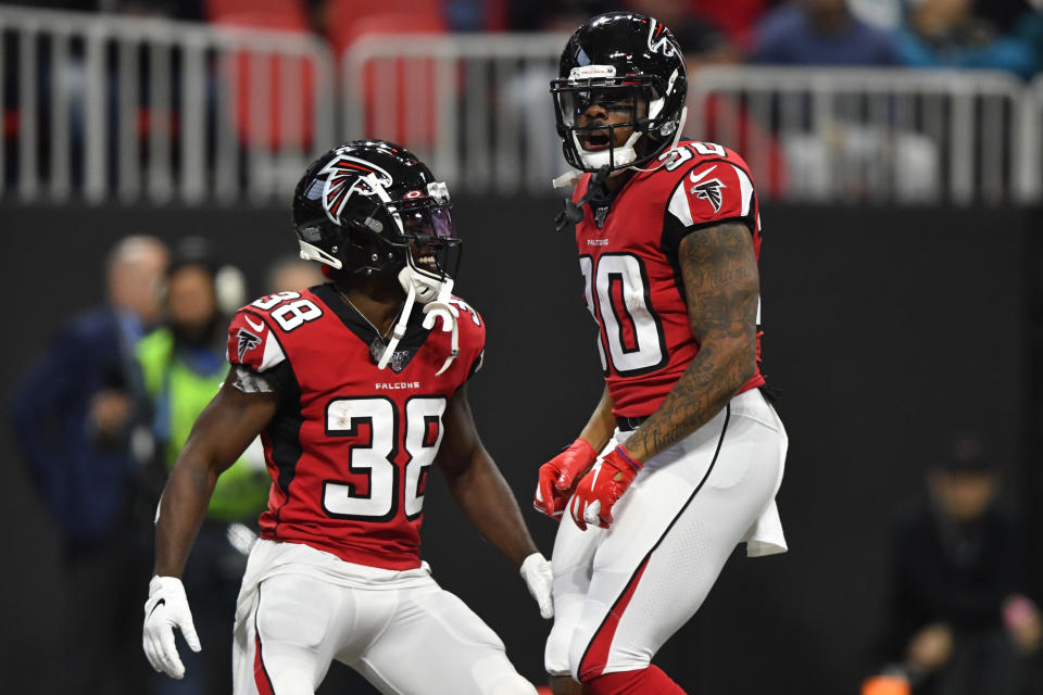 Atlanta Falcons running back Qadree Ollison (30) celebrates his touchdown with Atlanta Falcons running back Kenjon Barner (38) during the second half of an NFL football game against the Jacksonville Jaguars, Sunday, Dec. 22, 2019, in Atlanta. (AP Photo/John Amis)