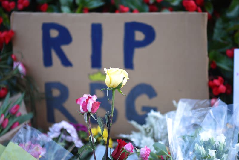 Flowers and tributes are seen as people gather in front of the U.S. Supreme Court following the death of U.S. Supreme Court Justice Ruth Bader Ginsburg, in Washington