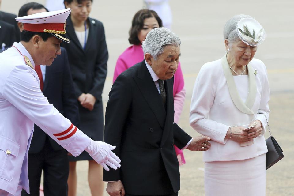 Japan's Emperor Akihito, center, and Empress Michiko, right, are shown the way during a wreath laying ceremony at the mausoleum of the late Vietnamese President Ho Chi Minh in Hanoi, Vietnam, Wednesday, March 1, 2017. (Luong Thai Linh/Pool Photo via AP)