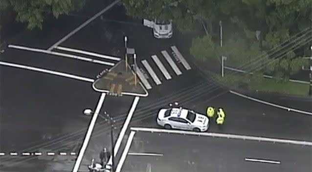 The woman was crossing the road when she was struck by a car which had its lights and sirens on. Source: 7News