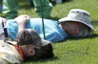 Patrons sleep on the 15th tee during the second round of the Masters golf tournament at the Augusta National Golf Club in Augusta, Georgia April 11, 2014. REUTERS/Mike Segar (UNITED STATES - Tags: SPORT GOLF)