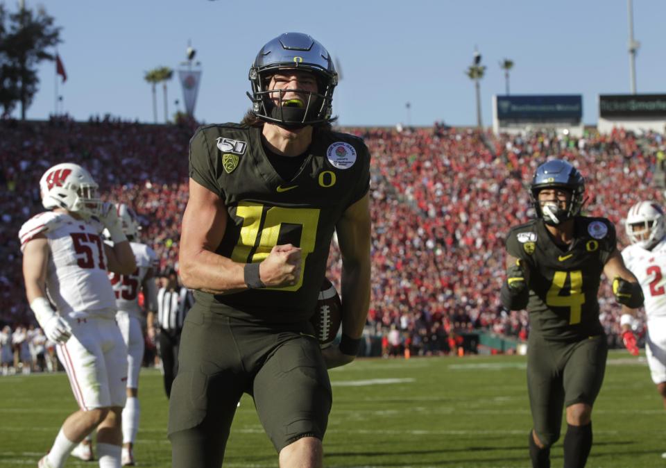 Oregon's Justin Herbert celebrates a first-quarter touchdown run against Wisconsin in the Rose Bowl Jan. 1, 2020. The Ducks won 28-27.