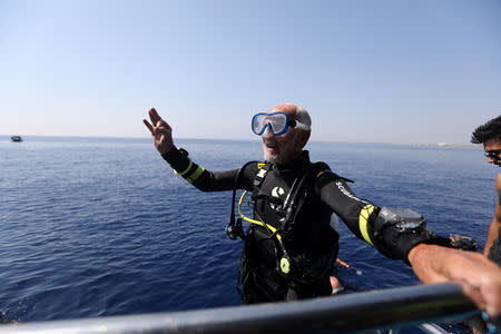 Ray Woolley, pioneer diver and World War 2 veteran, gestures after breaking a new diving record as he turns 95 by taking the plunge at the Zenobia, a cargo ship wreck off the Cypriot town of Larnaca, Cyprus September 1, 2018. REUTERS/Yiannis Kourtoglou
