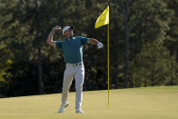 Rory McIlroy, of Northern Ireland, throws his ball to the gallery on the 18th green during the final round at the Masters golf tournament on Sunday, April 10, 2022, in Augusta, Ga. (AP Photo/David J. Phillip)