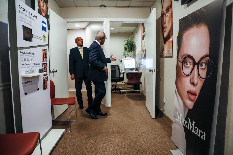 CEO of the National Business League INC. (the oldest and largest trade association for Black businesses) Ken Harris, left, meets with the owner of Heritage Optical George P. Barnes Jr. at their Heritage Optical location in northwest Detroit on Friday, Jan. 21, 2022. 