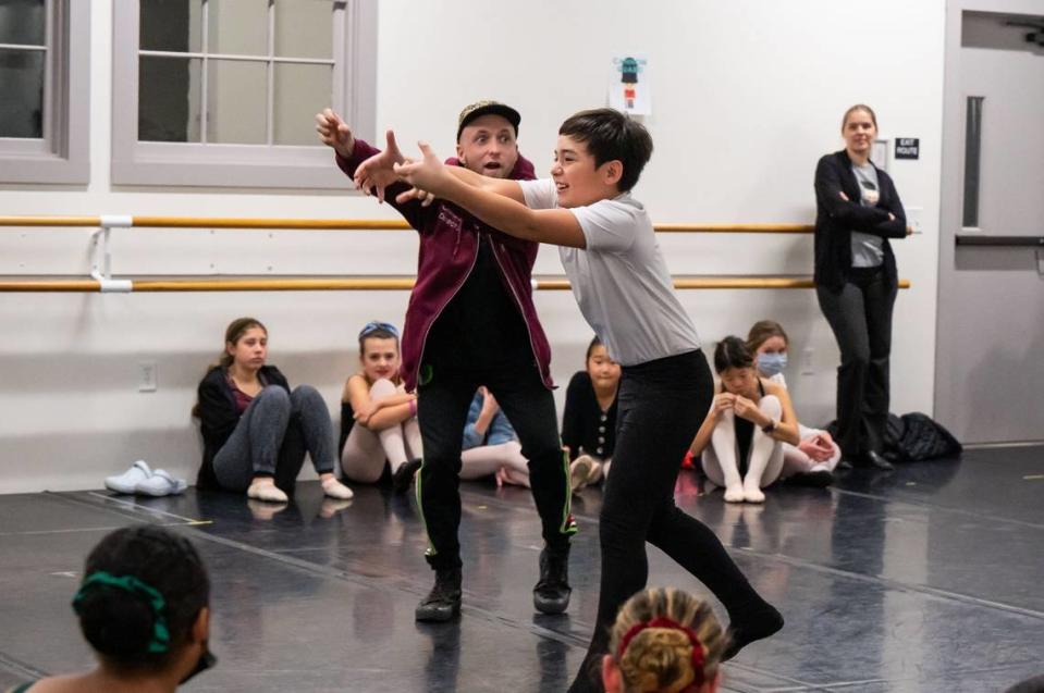 Ten-year-old Javier, right, of Sacramento, takes direction for his character “Fritz” from choreographer Colby Damon during rehearsals on Tuesday. Damon choreographed the newly staged production with fellow Sacramento natives Nicole Haskins and Julia Feldman.