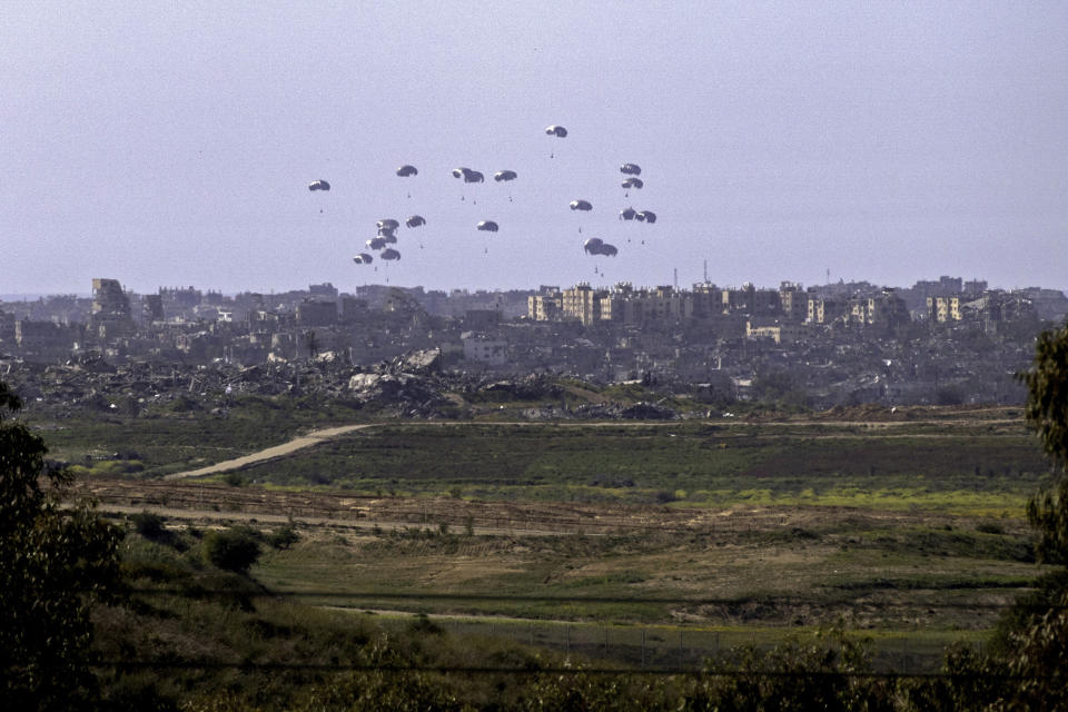 TOPSHOT - A general view taken from the Israeli side of the border shows aid parcels being airdropped over the northern Gaza Strip on March 5, 2024. Belgium sent on March 4 a military transport plane to join an international operation to airdrop aid into Gaza also involving the United States, France and Jordan, officials said. (Photo by Nicolas GARCIA / AFP) (Photo by NICOLAS GARCIA/AFP via Getty Images)