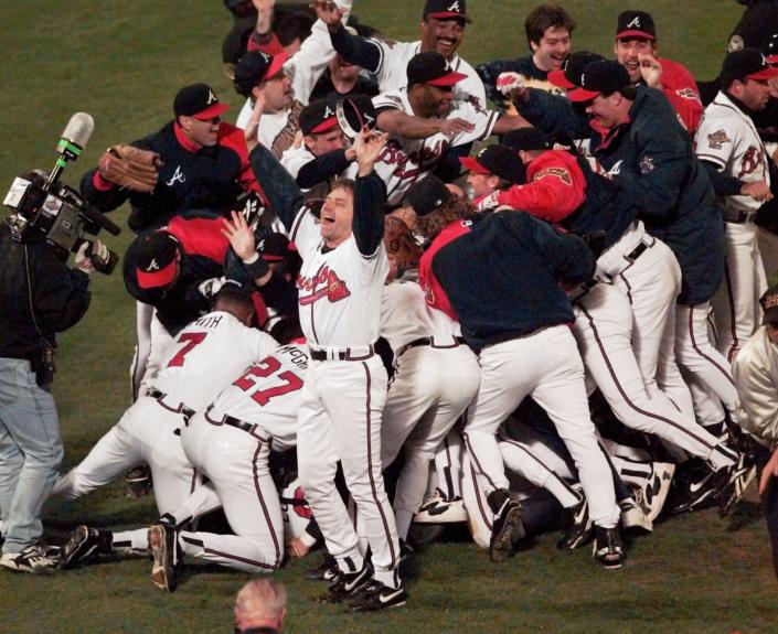 FILE - In this Oct. 28, 1995, file photo, the Atlanta Braves celebrate after Game 6 of the baseball World Series in Atlanta. The Braves defeated the Cleveland Indians 1-0 to win the series. When Atlanta United reached Saturday's MLS Cup final, the soccer team moved to the cusp of a truly rare accomplishment. There hasn't been a big league champion in this city since the Braves' title. (AP Photo/Ed Reinke, File)