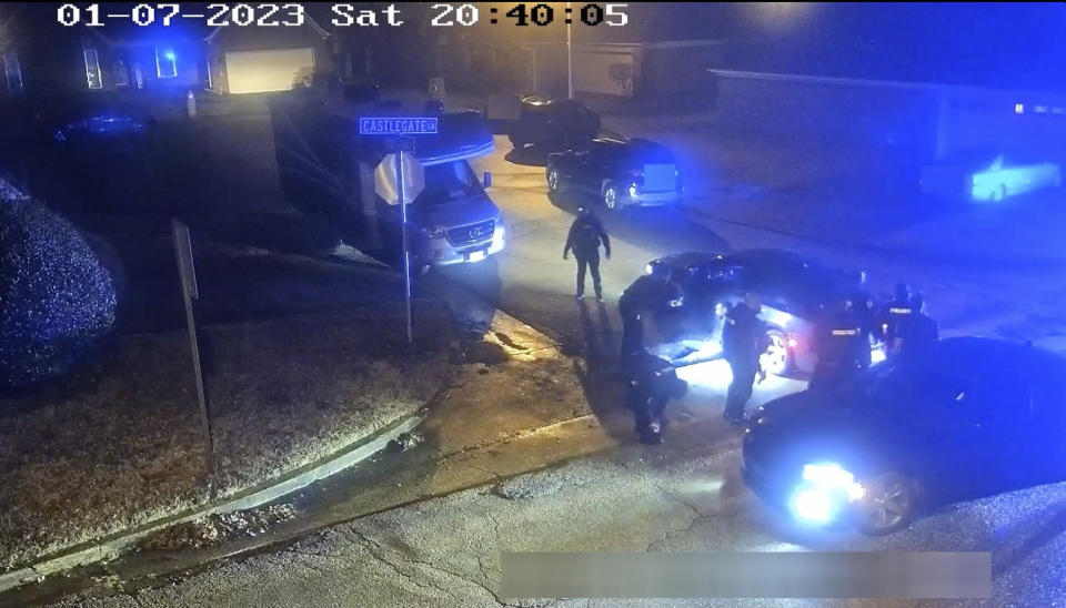 In this image from video released and partially redacted by the city of Memphis, Tenn., on Jan. 27, 2023, Tyre Nichols leans against a car after a brutal attack by five Memphis Police officers on Jan. 7, in Memphis. Officer Demetrius Haley, who is standing bent over in front of Nichols, is seen taking photographs of Nichols, which he sent to other officers and a female acquaintance. The new revelation about Haley's actions were released Tuesday, Feb. 7, in documents that provide a scathing account of what authorities called the “blatantly unprofessional” conduct of the officers involved in the fatal beating of Nichols. (City of Memphis via AP)