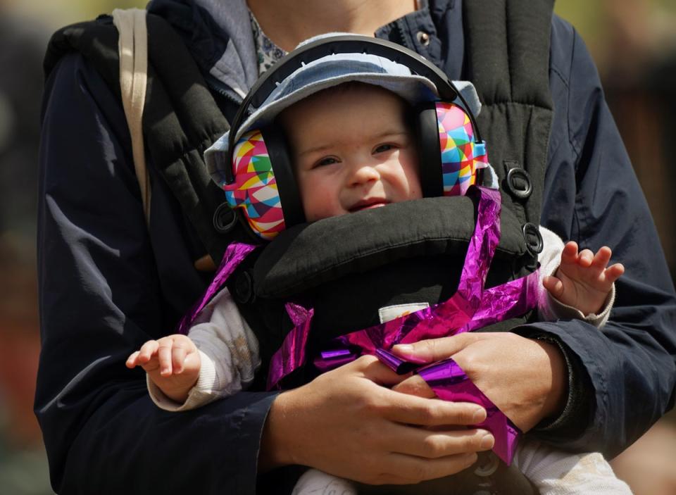 A young fan had ear protectors on for the brass music from the Black Dyke Band on Sunday afternoon (Yui Mok/PA) (PA Wire)