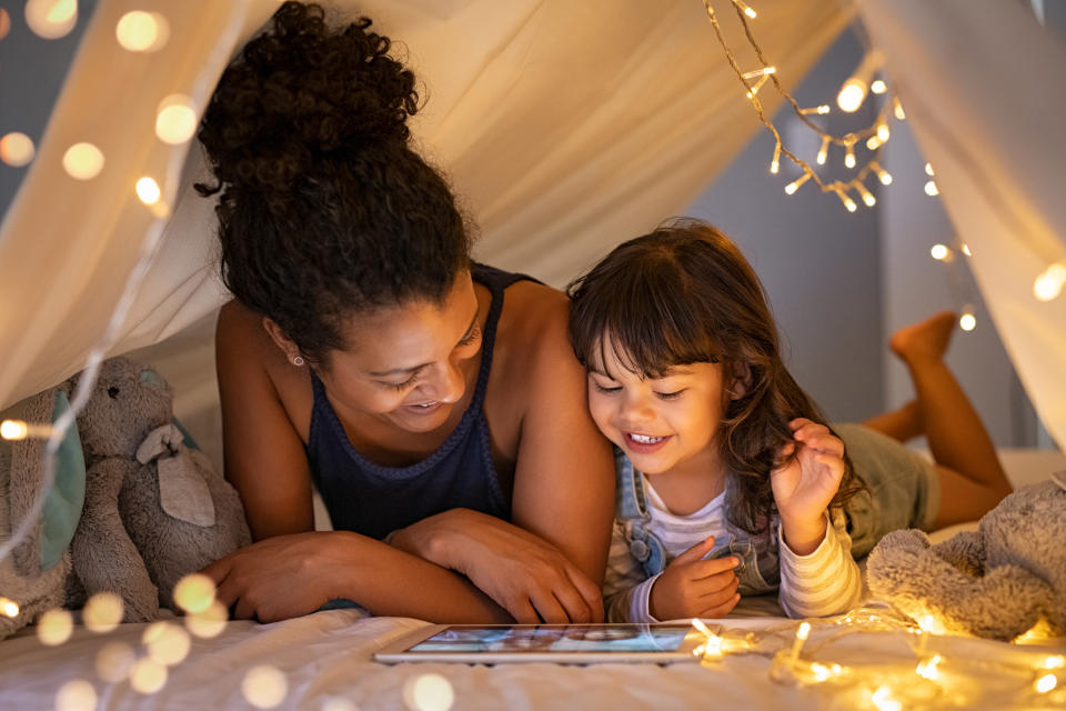 mom and daughter in a tent with lights