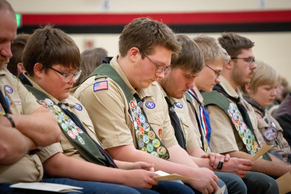Boy Scouts from John-Mikal McLuer's troop were honorary casket bearers during a memorial for him and his brothers Wednesday.