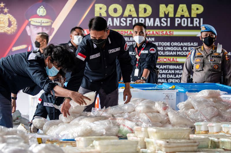 Indonesian police arrange drug evidence during media conference in Jakarta
