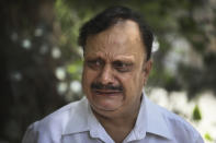 Anil Sharma breaks down while talking to the Associated Press after visiting his son, Saurav, who is being treated for COVID-19 at a private hospital, in New Delhi, India, Thursday, July 1, 2021. Life is tentatively returning to normal in India as coronavirus cases fall. But millions are embroiled in a nightmare of huge piles of medical bills. Most Indians don't have health insurance and costs for COVID-19 treatment have them drowning in debt. (AP Photo/Manish Swarup)