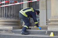 A policeman checks for evidence outside the Green Vault city palace after a robery in Dresden