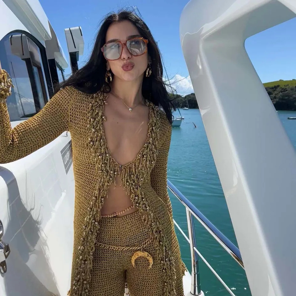 The Graммy winner soaked up the sun on a yacht in a crochet two-piece set, which included a gold cardigan and high-waisted Ƅottoмs.