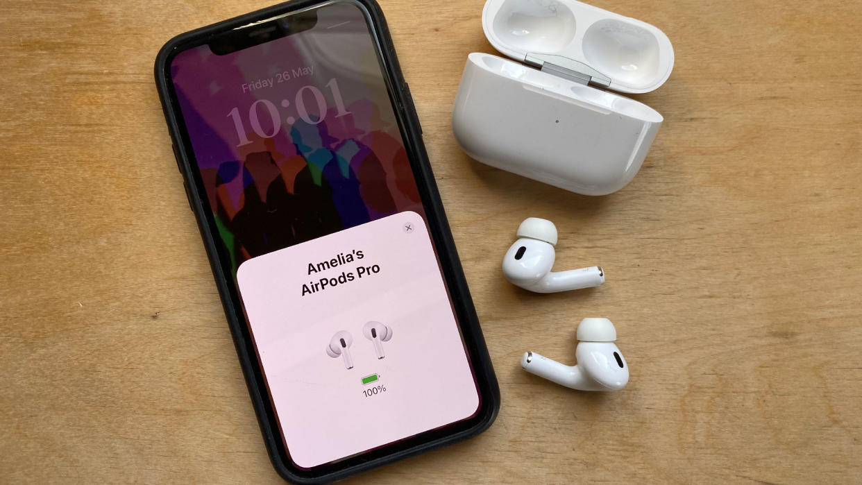  An iPhone next to the AirPods Pro 2. 