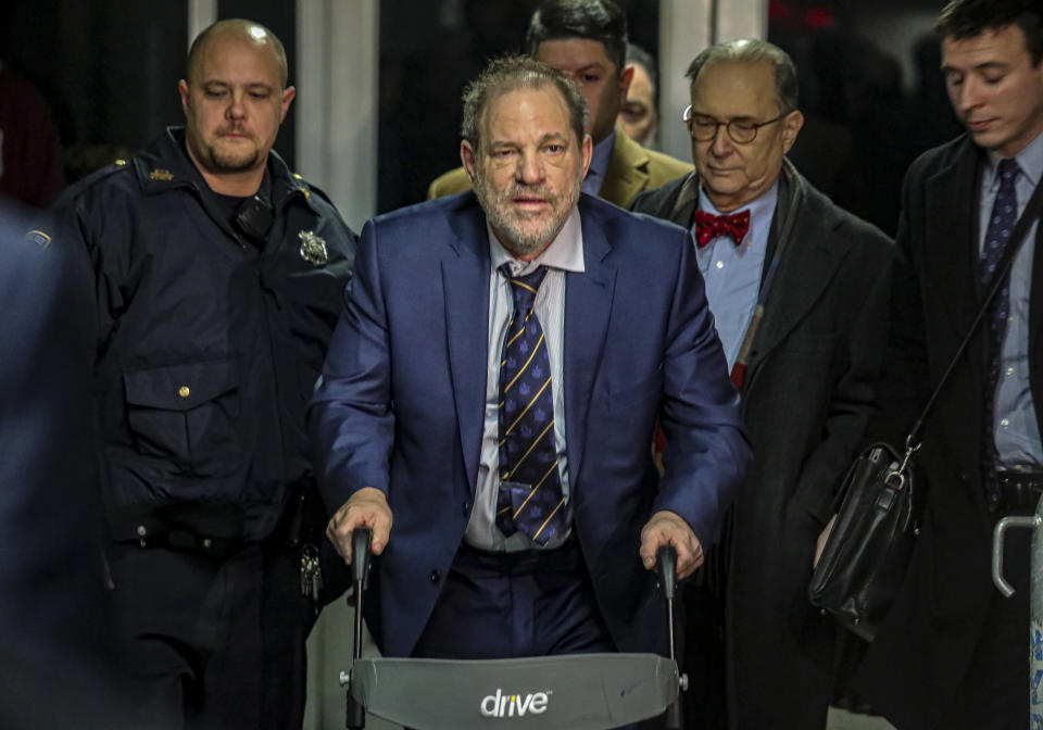 Harvey Weinstein, second from left, leaves Manhattan's Criminal Court after prosecutors completed their closing argument in his rape trial, Friday, Feb. 14, 2020, in New York. (AP Photo/Bebeto Matthews)