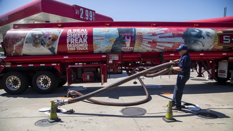 A fuel tanker driver delivers a 9000 gallon load of fuel at the Sheetz in Raleigh, N.C., Thursday, May 13, 2021. Operators of the Colonial Pipeline say they began the process of moving fuel through the pipeline again on Wednesday, six days after it was shut down because of a cyberattack. (Travis Long/The News & Observer via AP)