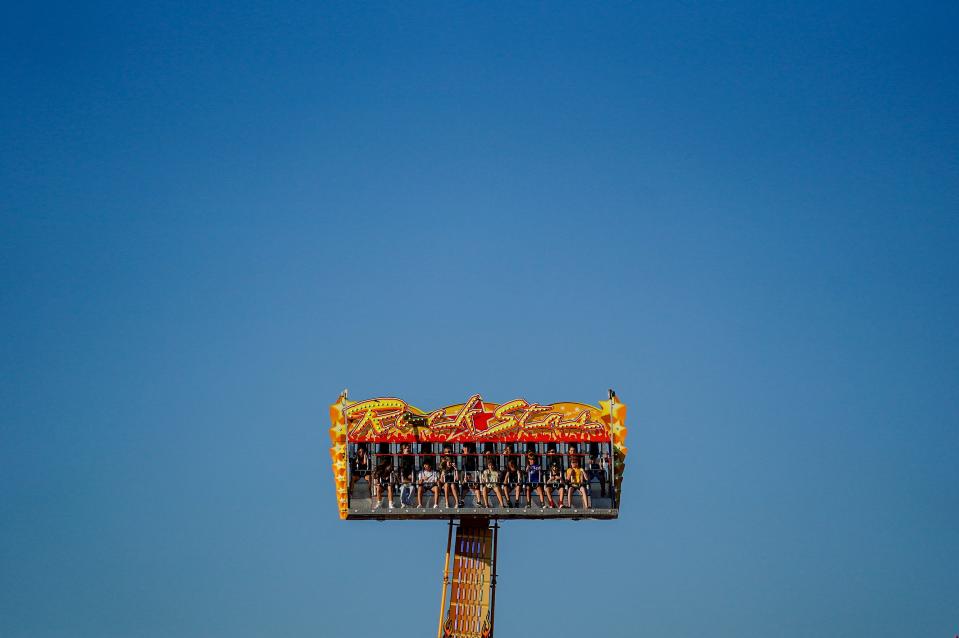 People react as they spin on a ride during the Ankeny Area Chamber of Commerce is hosted SummerFest near the Kirkendall Public Library Saturday, July 9, 2022 in Ankeny. 