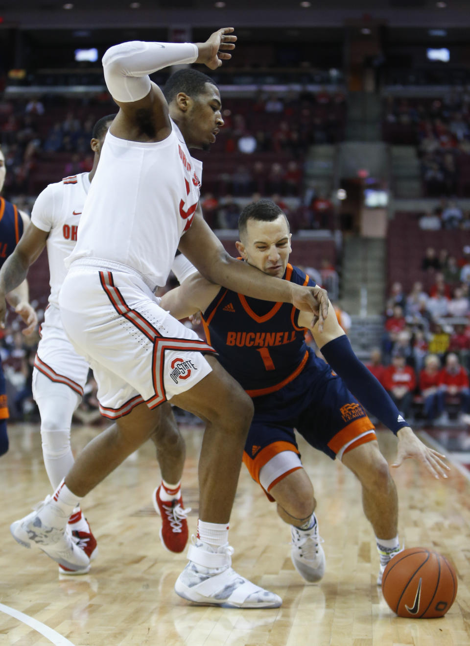 Bucknell's Kimbal Mackenzie, right, drives to the basket against Ohio State's Kaleb Wesson during the first half of an NCAA college basketball game Saturday, Dec. 15, 2018, in Columbus, Ohio. (AP Photo/Jay LaPrete)