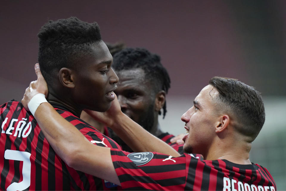 AC Milan's Rafael Leao, left, celebrates with his teammate Ismael Bennacer after scoring his side's 3rd goal during the Serie A soccer match between AC Milan and Juventus at the Milan San Siro Stadium, Italy, Tuesday, July 7, 2020. (Spada/LaPresse via AP)