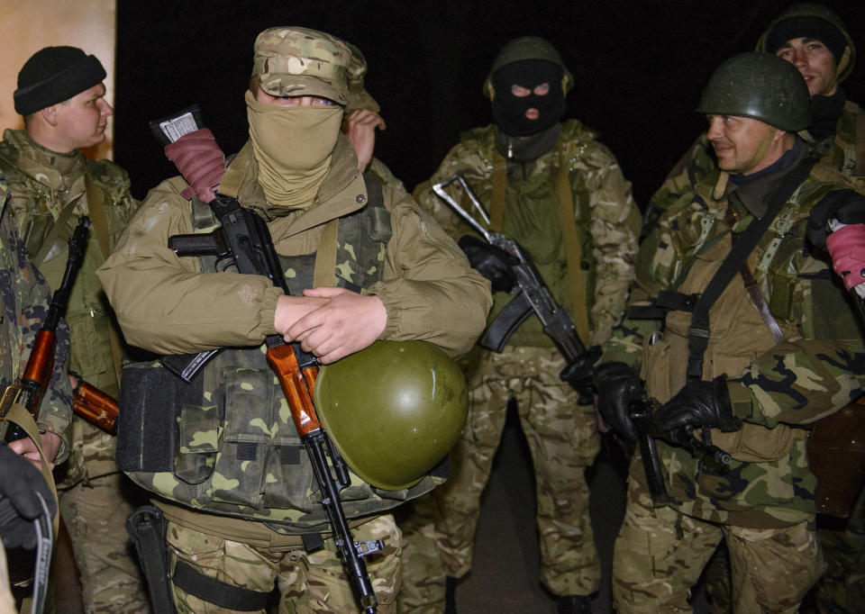 In this photo taken on Tuesday, April 15, 2014, Ukrainian army troops guard an airport in Kramatorsk, eastern Ukraine. In the first Ukrainian military action against a pro-Russian uprising in the east, government forces clashed Tuesday with about 30 armed gunmen at a small airport in Kramatorsk. (AP Photo/Olga Ivashchenko)