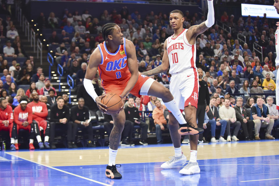 Oklahoma CIty Thunder forward Jalen Williams (8) looks for an open teammate as he looks to pass around Houston Rockets forward Jabari Smith Jr (10) in the first half of an NBA basketball game, Tuesday, Feb. 27, 2024, in Oklahoma City. (AP Photo/Kyle Phillips)