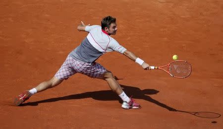 Stan Wawrinka of Switzerland returns the ball to Novak Djokovic of Serbia during their men's final match at the French Open tennis tournament at the Roland Garros stadium in Paris, France, June 7, 2015. REUTERS/Gonzalo Fuentes